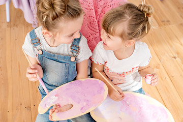 Little sisters of the artist in a floral studio