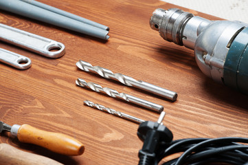 Naklejka premium Instruments on the table, drill, hammer,