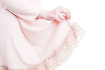 Close-up of fashion woman hand holding her pink dress