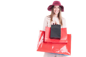 Portrait of cheerful attractive female holding colorful shopping