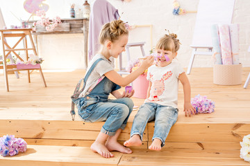 Little sisters of the artist in a floral studio