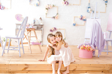 Little sisters playing in the floral studio