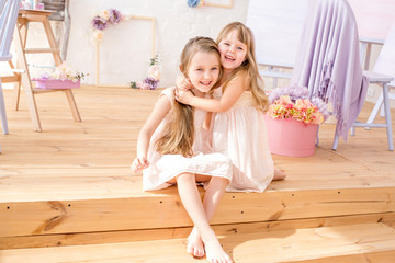 Little sisters playing in the floral studio