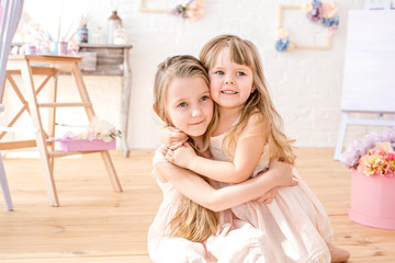 Little sisters playing in the floral studio