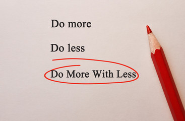 Do More With Less in red circle with pencil on textured paper