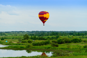 Fototapeta premium air balloon flight over the trees on a background of clouds