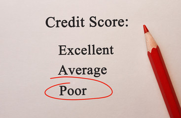 Credit Score Poor in red circle with pencil on textured paper