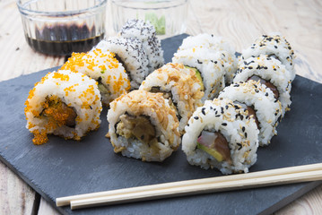 Sushi rolls on a slate plate