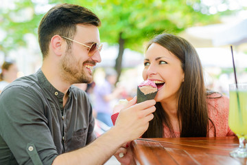 Cheerful couple eating ice cream
