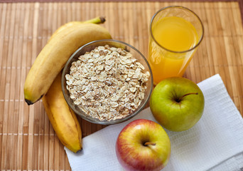 Breakfast. Oatmeal with milk, juice, banana, apple and lemon