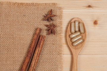 Herbal capsules on wooden spoon. herb for healthy