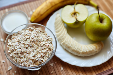 Breakfast. Oatmeal with milk, juice, banana, apple and lemon
