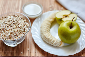 Breakfast. Oatmeal with milk, juice, banana, apple and lemon