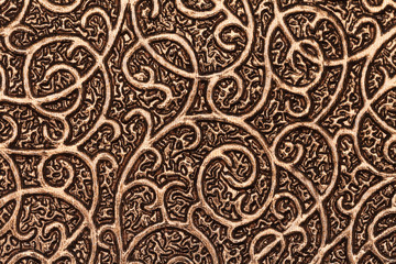 Gold plated metallic textured background with patterns.