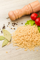 Pasta, tomatoes and pepper on a wooden background