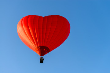 Hot air balloon - red heart on a background of blue sky