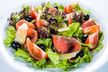 Fish salad - grilled salmon and vegetables. Restaurant food concept