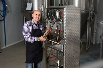 Male worker on beer brewery.