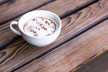 Cappuccino on the wooden table
