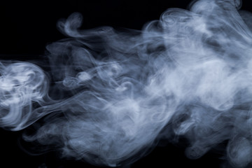 Cloud of smoke on black background. Selective focus