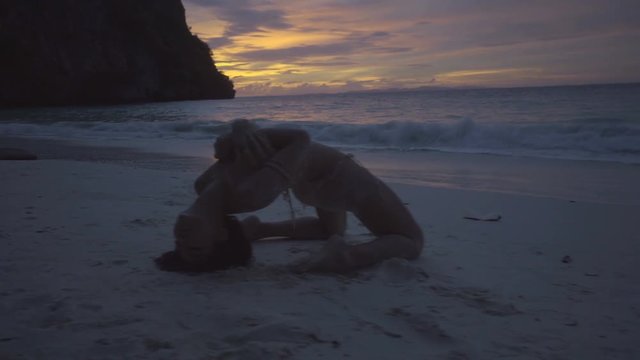 Asian beautiful woman in crochet bikini posing on the beach. 4k video of sexy girl posing on the beach with see and sky background at the outstanding sunset.