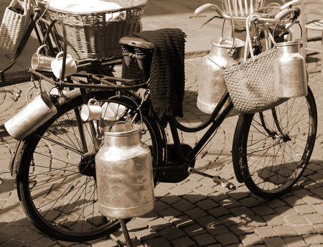 Fototapeta old bicycle of milkman for transporting milk cans