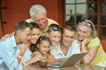 family sitting with laptop