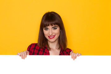 Smiling Girl Behind White Banner