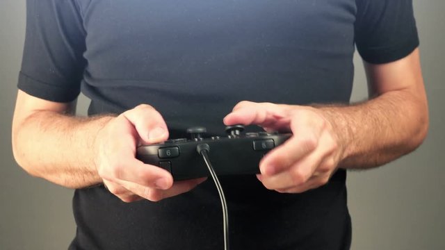Man playing video games with gamepad controller, gaming and entertainment concept