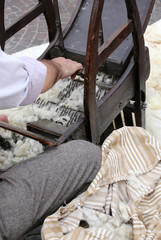 carder while carding with wooden machine to make the mattresses