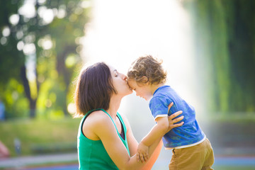 Naklejka premium Mother kissing baby.