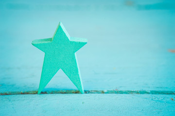 Fototapeta na wymiar blue wooden star on a blue wooden background