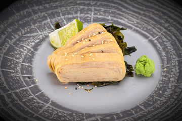 Japanese cuisine. Sushi. Tomago  sashimi on a round plate