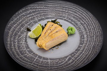 Japanese cuisine. Sushi. Tomago  sashimi on a round plate