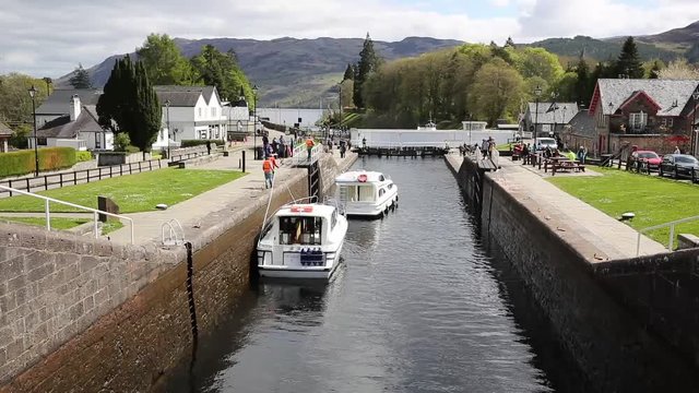 Boats moving through lock gates Caledonian Canal Fort Augustus Scotland UK by Loch Ness