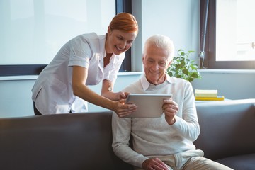 Nurse and senior man using a digital tablet