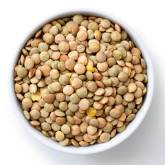 White ceramic bowl of green uncooked lentils isolated on white f