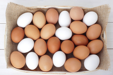 Brown and white chicken/hen eggs on wooden table