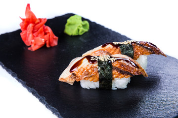 Sushi Set and sushi rolls on black stone slate. Restaurant food concept.