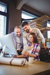 Fototapeta premium Businesswoman showing documents to male coworkers