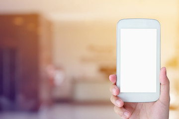 woman hand hold mobile smartphone with hotel lobby