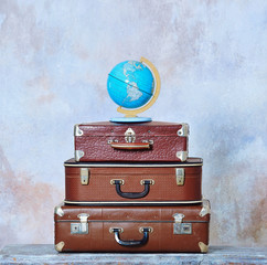 Travel background concept with old fashioned suitcases and global map