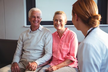 Nurse talking to senior couple