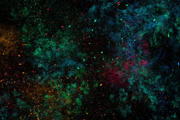 Colourful abstract powder explosion on a black background