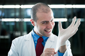 Creepy doctor wearing a glove