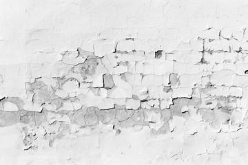 Concrete wall with peeling white paint, texture