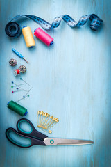 sartorial meter and scissors on the old wooden background