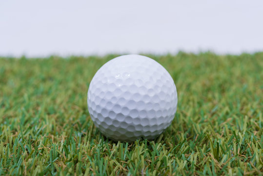 White Golf ball on green grass