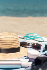 Typical beach gear of beauty products and care with female things for day in summer