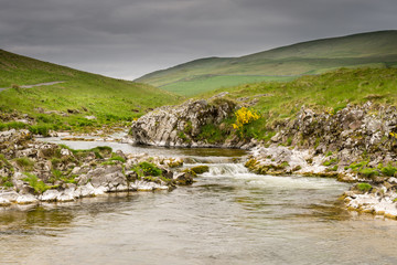River Coquet cascades down Coquetdale, flowing from the Cheviot Hills in Northumberland